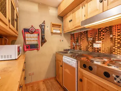 a kitchen with a sink and a stove top oven at Apartment Albert by Interhome in Penia