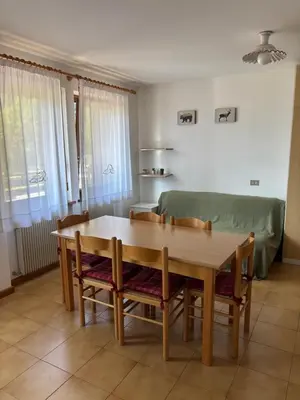 a living room with a table and a couch at Il Cirmolo in Canale dʼAgordo