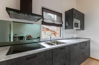 a kitchen with a sink and a large mirror at Sass Maor - Caminetto in Transacqua