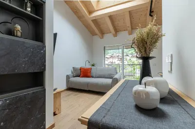 a living room with a couch and a table at Sass Maor - Caminetto in Transacqua