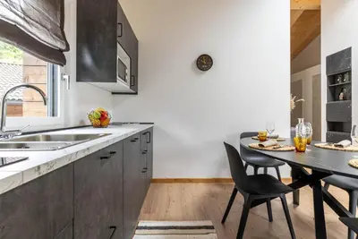 a kitchen with a table and chairs and a sink at Sass Maor - Caminetto in Transacqua