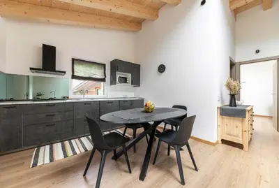 a kitchen and dining room with a table and chairs at Sass Maor - Caminetto in Transacqua