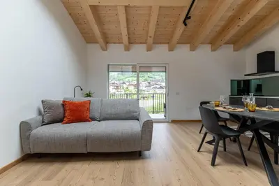 a living room with a couch and a table at Sass Maor - Caminetto in Transacqua