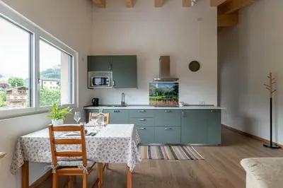 a kitchen with a table with a fish tank at Pavione - Caminetto in Transacqua