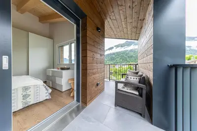 a room with a bed and a balcony with a view at Pavione - Caminetto in Transacqua