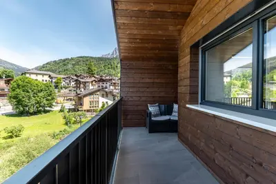 a balcony with a view of the mountains at Pavione - Caminetto in Transacqua