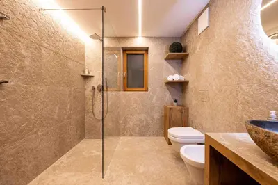 a bathroom with a shower and a toilet and a sink at Sirona Stay - Private Spa Retreat near Bolzano Dolomites - Romantic Stay with Sauna Whirlpool Garden Garage Free Bolzano Card in San Genesio Atesino
