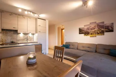 a living room with a couch and a table at Sirona Stay - Private Spa Retreat near Bolzano Dolomites - Romantic Stay with Sauna Whirlpool Garden Garage Free Bolzano Card in San Genesio Atesino