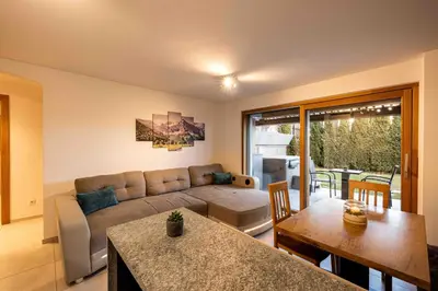 a living room with a couch and a table at Sirona Stay - Private Spa Retreat near Bolzano Dolomites - Romantic Stay with Sauna Whirlpool Garden Garage Free Bolzano Card in San Genesio Atesino