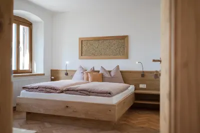 a bedroom with a large bed in a room at Stammhaus Vetterer in Lana