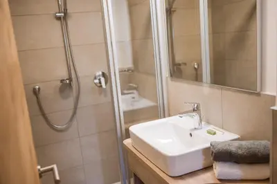a bathroom with a sink and a shower at Stammhaus Vetterer in Lana
