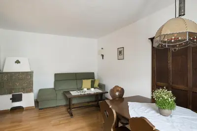 a living room with a table and a couch at Stammhaus Vetterer in Lana