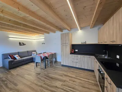a ski resort with snow covered mountains in the background at Miravalli Home in Gosaldo