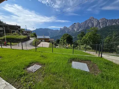 a group of houses in front of a mountain at Miravalli Home in Gosaldo