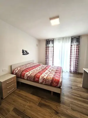 a bedroom with a view of the mountains through a window at Miravalli Home in Gosaldo