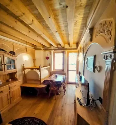 a living room with a couch and a table at Beautiful apartment in Zoldo Alto Dolomites in Pianaz