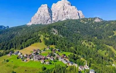 a village on a hill in front of a mountain at Beautiful apartment in Zoldo Alto Dolomites in Pianaz