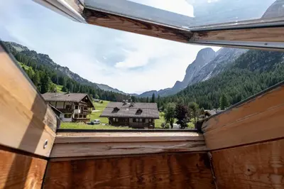 a view from a window of a mountain at Un respiro nel bosco - Residence Cèsa Da Mont in Penia