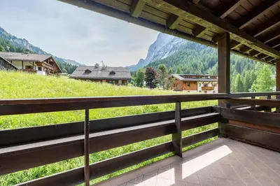 a balcony with a view of a mountain at Un respiro nel bosco - Residence Cèsa Da Mont in Penia