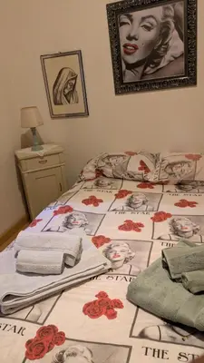 a bed with a bedspread with a woman on it at Il Giardino dell'Eden in Caprile