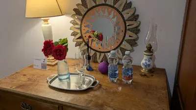 a table with a mirror and some bottles on it at Il Giardino dell'Eden in Caprile