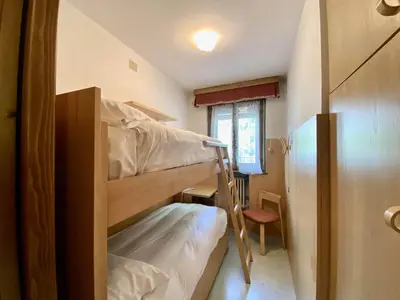 a small room with two bunk beds in it at Cozy flat in amazing central location in Cortina dʼAmpezzo
