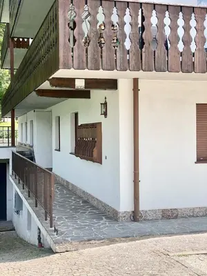 a building with a staircase and a balcony at Cozy flat in amazing central location in Cortina dʼAmpezzo