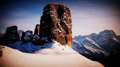 a person standing on top of a snow covered mountain at Cozy flat in amazing central location in Cortina dʼAmpezzo