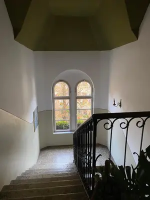 a stairway with two windows and a stair case at Vintage Castle 