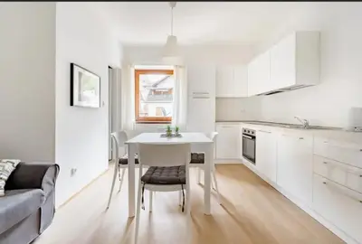 a white kitchen with a white table and chairs at Vintage Castle 