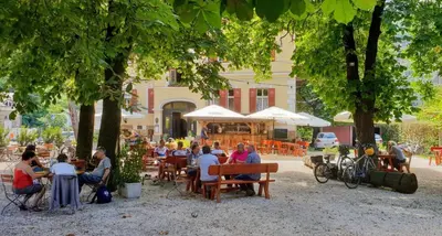 a group of people sitting at tables under trees at Vintage Castle 
