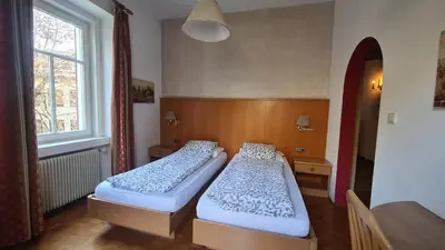 two beds sitting in a room with a window at Vintage Castle 