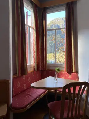 a table and a bench in a room with a window at Vintage Castle 
