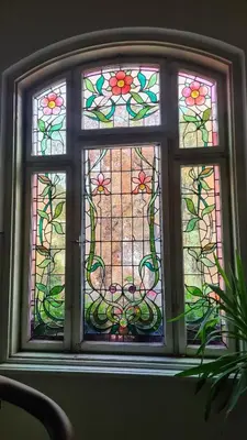 a stained glass window in a room with a plant at Vintage Castle 