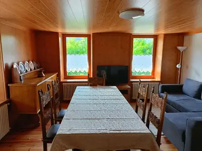 a living room with a table and a couch at La Casetta in San Vito di Cadore