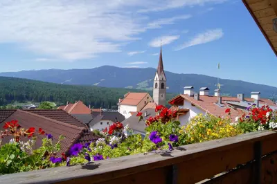 a view from a balcony of a town with flowers at Apartment Oberhauserhof in Falzes