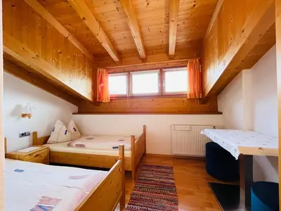 a room with two beds and a window at Apartment Oberhauserhof in Falzes