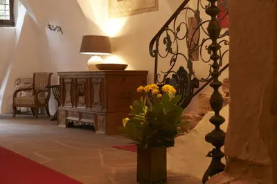 a room with a vase of flowers on the floor at Schloss Englar in Appiano sulla Strada del Vino