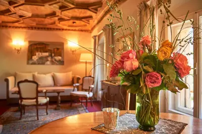 a vase filled with flowers sitting on a table at Schloss Englar in Appiano sulla Strada del Vino