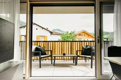 a patio with a table and chairs on a balcony at Suite by Silvy in Vipiteno