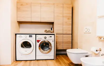 a bathroom with a washing machine and a toilet at Suite by Silvy in Vipiteno