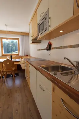 a kitchen with a sink and a counter top at Apartments DAMONT in Santa Cristina in Val Gardena