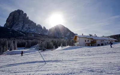 a group of people skiing on a snow covered mountain at Apartments DAMONT in Santa Cristina in Val Gardena