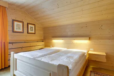a bedroom with a bed in a wooden cabin at Apartment Laura in Ortisei