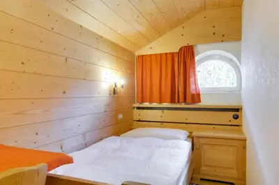 a small room with a bed and a window at Apartment Laura in Ortisei