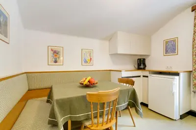 a kitchen with a table with a bowl of fruit on it at Apartment Laura in Ortisei