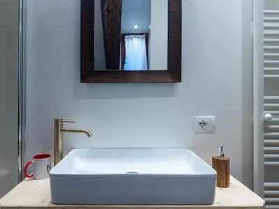 a white sink in a bathroom with a mirror at Picia Ciasa - Charming attic in paradise in San Vito di Cadore