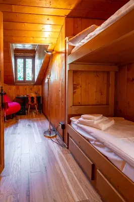 a bedroom with two bunk beds in a cabin at Picia Ciasa - Charming attic in paradise in San Vito di Cadore