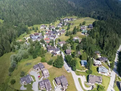 an aerial view of a house in a forest at Picia Ciasa - Charming attic in paradise in San Vito di Cadore