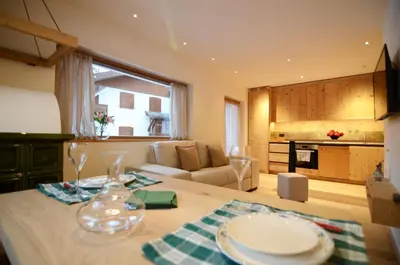 a kitchen and living room with a table with plates on it at Villa Primavera in Alvera